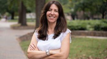 Francesca Tripodi stands on a brick pathway on the campus of U.N.C.-Chapel Hill